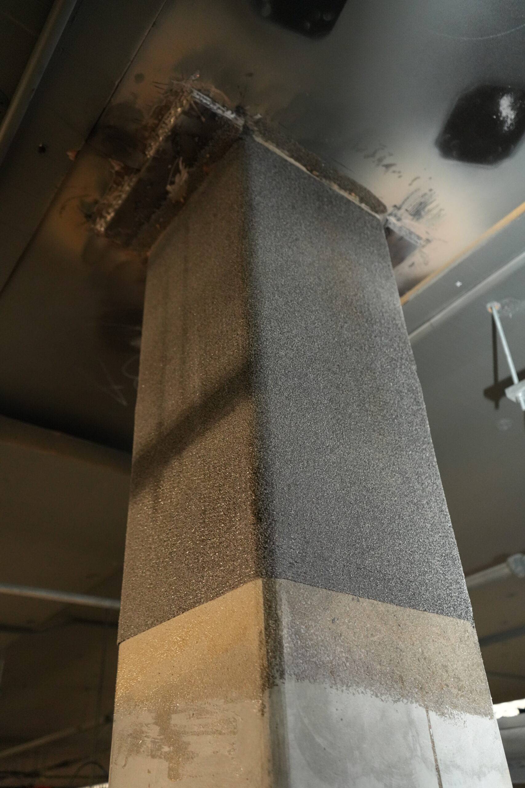 Completed CFRP-strengthened column with protective skim coat finish at Nedlands Shopping Centre
