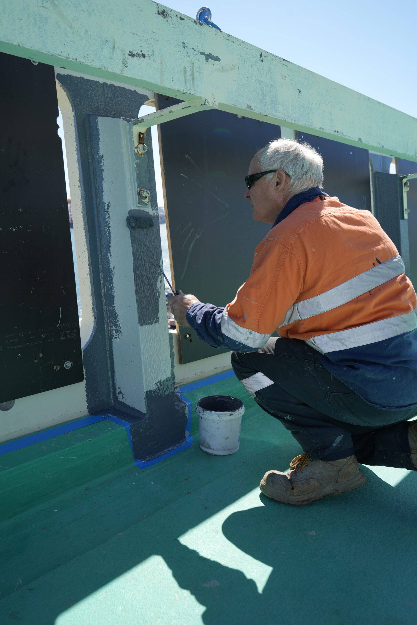Technician applying seamless liquid waterproofing membrane to concrete surface
